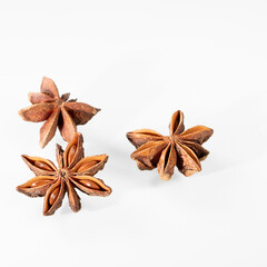 Aromatic anise stars on clean white background for culinary and wellness concepts