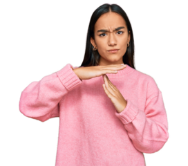 Young asian woman wearing casual winter sweater doing time out gesture with hands, frustrated and serious face