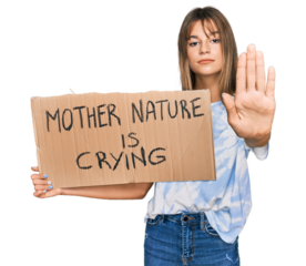 Teenager caucasian girl holding mother nature is crying protest cardboard banner with open hand doing stop sign with serious and confident expression, defense gesture