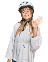 Teenager caucasian girl wearing bike helmet showing and pointing up with fingers number five while smiling confident and happy.