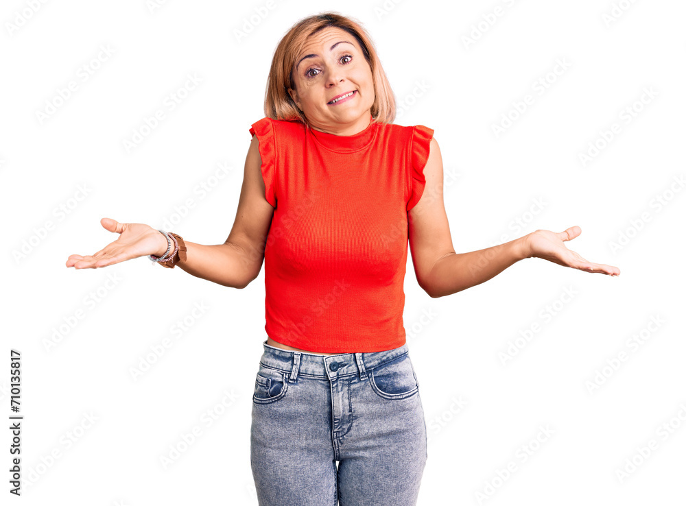 Canvas Prints young blonde woman wearing casual clothes clueless and confused expression with arms and hands raise