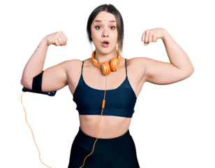 Young hispanic girl wearing sportswear doing strong gesture afraid and shocked with surprise and amazed expression, fear and excited face.