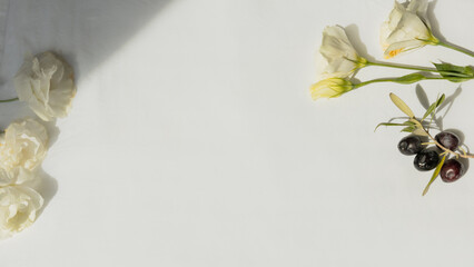 Olives and carnation flowers flat lay on soft off-white background, feminine authentic minimal...