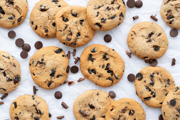 Cookies with chocolate drops on white crumpled paper. Cookies background. Close-up, top view, flat lay