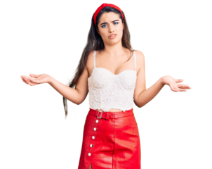 Brunette teenager girl wearing elegant look clueless and confused expression with arms and hands raised. doubt concept.