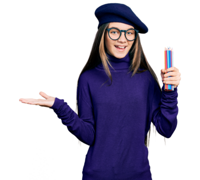 Young brunette girl with long hair holding colored pencils celebrating achievement with happy smile and winner expression with raised hand