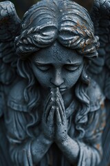 Fototapeta na wymiar Crying and praying angel statue portrait 