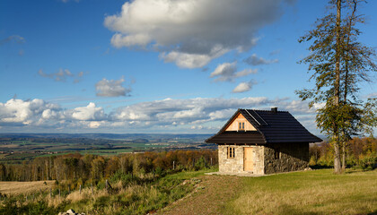 Fototapeta na wymiar Forest hut and zahori from the road below Javornik. Autumn. Hostyn hills. Czechia. 