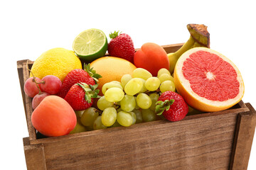 Wooden box with different fresh fruits on white background