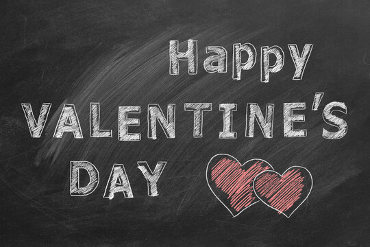 Happy Valentines day. Chalk lettering on the blackboard.