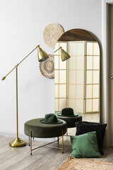 Interior of hallway with mirror, door and pouf