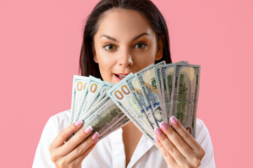 Young woman with dollar banknotes on pink background, closeup