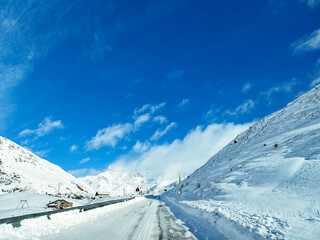 Fototapeta na wymiar Snowy road in the Italian alps
