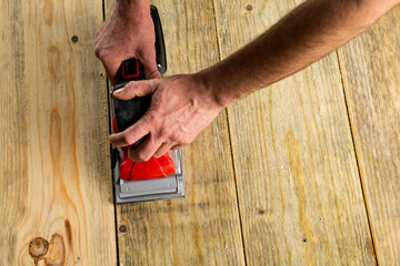 Sanding machine in male hand