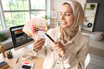 Muslim interior designer with color palettes in office - obrazy, fototapety, plakaty