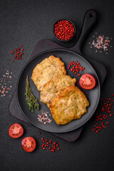 Delicious juicy fried chicken or pork pancakes with salt, spices and herbs