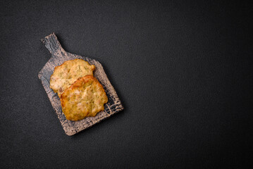 Delicious juicy fried chicken or pork pancakes with salt, spices and herbs