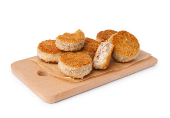 Wooden board of tasty meat cutlets on white background