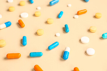 Many different pills on orange background