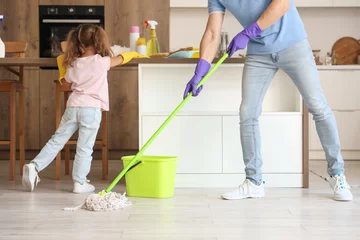Fotobehang Cute little girl with her dad cleaning in kitchen © Pixel-Shot