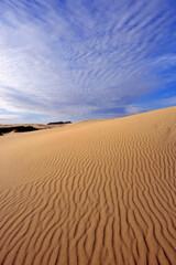 Fototapeta na wymiar Sand dunes and beautiful cloud covered skies