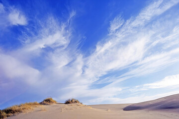 Fototapeta na wymiar Sand dunes and beautiful cloud covered skies
