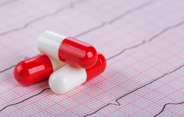 medical pills on the background of a medical cardiogram