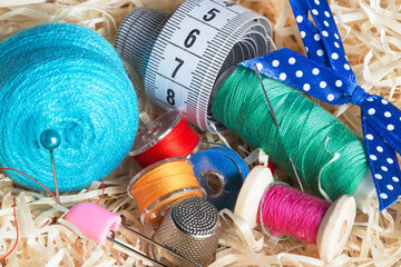 set of sewing threads, on spools, sewing needle
