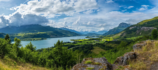 Fototapeta na wymiar Panoramic view of green mountains and lake