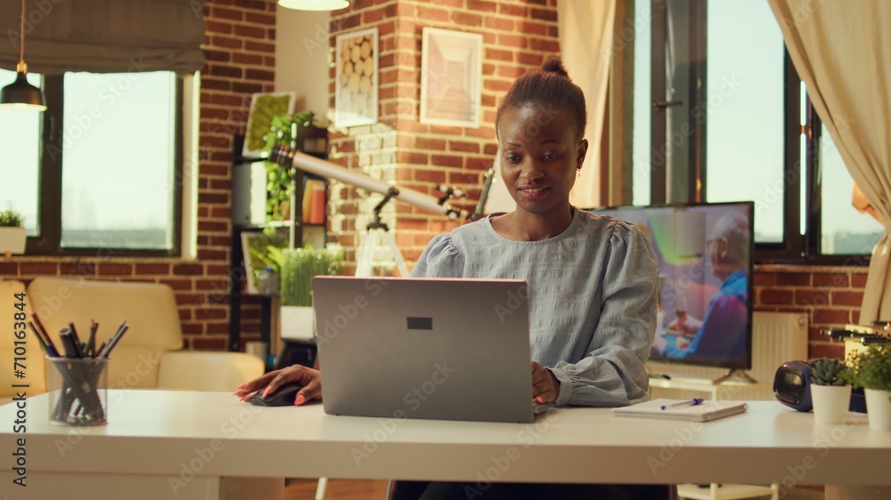 Poster freelancer works at home and solves online based tasks during sunset hour. woman working remotely, r