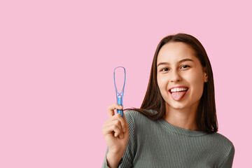 Beautiful young woman with tongue scraper on pink background - obrazy, fototapety, plakaty