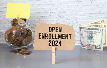 open enrollment 2024. text on a sticker next to money and banknotes