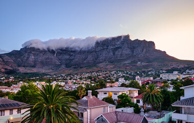 Table Mountain peak covered with cloud and suburb nestled on the foothills of Table Mountainat...
