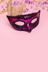 Festive face mask for carnival celebration on colored background with copy space