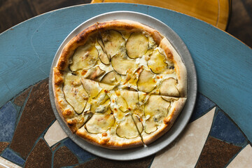 Delicious pizza with crispy sides, pear and truffle. Food photography, menu, mockup.