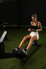 Girl doing exercise rowing machine in gym © Nikita
