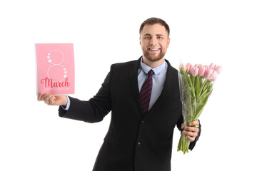 Handsome businessman with tulips and greeting card on white background. International Women's Day celebration