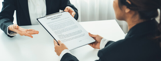 Business executive signing contract agreement document on the bale with the help from company attorney or lawyer service in law firm office. Business investing and finalizing legal processing. Shrewd - obrazy, fototapety, plakaty