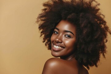 Beautiful portrait of smiling African American woman with healthy skin and curly hair.