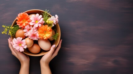 Hands holding a bowl of natural-colored eggs amidst spring flowers on dark background. Banner with copy space. Top view. Suitable for Easter content, spring-themed designs, and cooking publications.