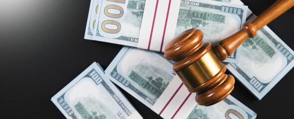 Gavel and dollars banknotes on table
