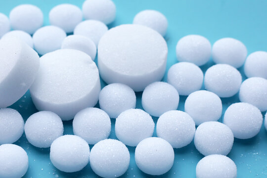 White mothballs on blue background.