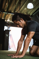 man in the gym stretching