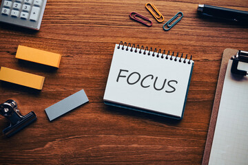 There is notebook with the word FOCUS. It is as an eye-catching image.