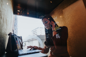 A businesswoman in a phone booth discussing a project and negotiating with a client. Busy office environment with employees working and having meetings. Dedicated to company growth and profit. - obrazy, fototapety, plakaty