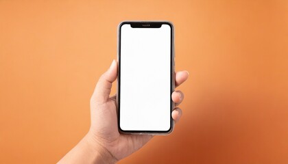 Fototapeta na wymiar Hand using smartphone with blank screen, isolated on orange background 