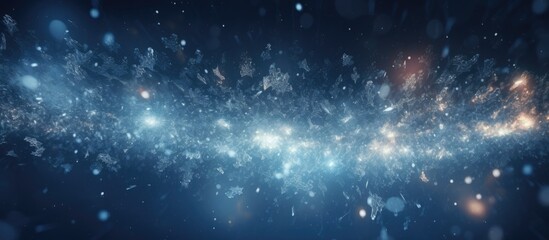 Abstract blur created by snowflakes falling on a dark winter night.