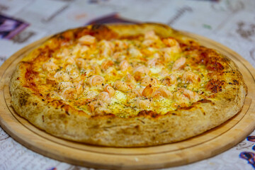 Traditional shrimp pizza with creamy catupiry cheese in selective focus.