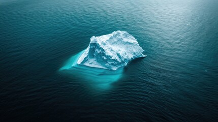 A majestic iceberg slowly melts in the crystal blue waters of the arctic ocean, a testament to the power and fragility of nature