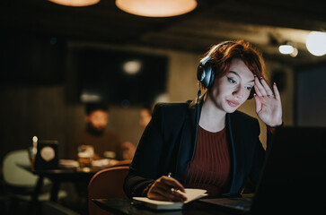 A confident businesswoman working extra hours in a creative office, discussing data analytics for global expansion. She is persistent and successful in her innovative business strategies.